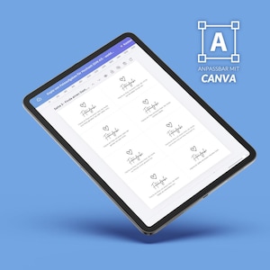 May include: A tablet displaying a digital document with multiple rectangular cards, each featuring a heart icon and the German text 'Fotoaufgabe'. The screen interface includes a top navigation bar and a logo in the corner with the text 'ANPASSBAR MIT CANVA'.
