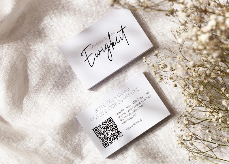 Puede incluir: Dos tarjetas rectangulares blancas con texto en negro. La tarjeta superior presenta el texto en cursiva "Momente f&uuml;r die Ewigkeit". La tarjeta inferior incluye un c&oacute;digo QR y el texto "BITTE TEILE DEINE FOTOS & VIDEOS MIT UNS. Scanne den QR-Code mit deinem Smartphone und lade deine Aufnahmen hoch. Lieben Dank! Lisa & Markus".
