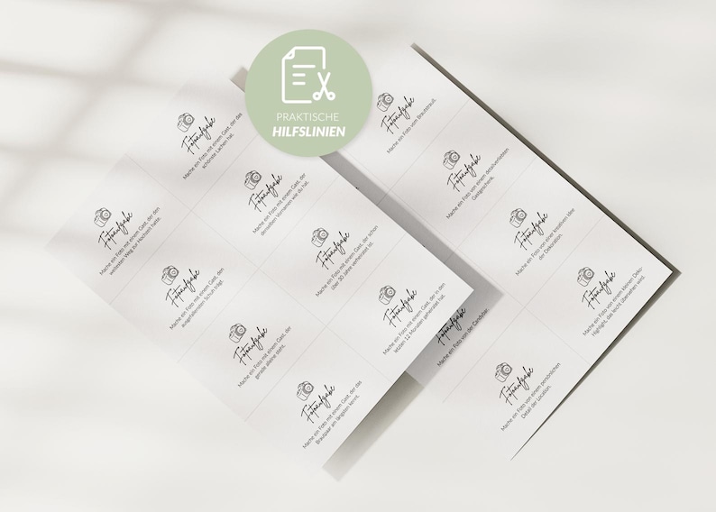 May include: Two sheets of white stickers with a grid pattern. Each sticker features a camera icon and handwritten text in black. A green circle with text and a scissors icon is in the upper left corner.