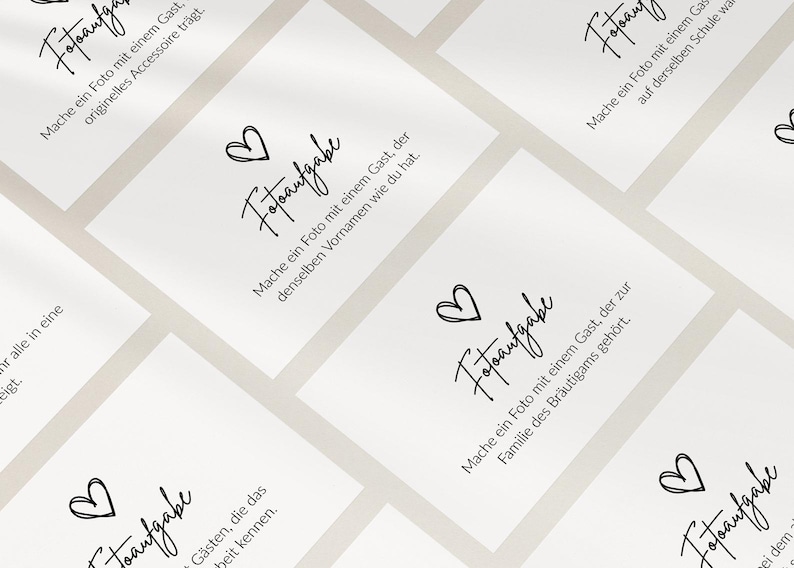 May include: A collection of white rectangular cards featuring the black text 'Fotoaufgabe' and a hand-drawn heart icon. Each card displays a unique German instruction for wedding guests to take specific photos, arranged in a repeating grid pattern.