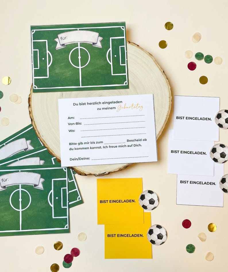 May include: A collection of soccer-themed party invitations and decorations. The invitations feature a green soccer field design with the word "f&uuml;r" on top. Additional cards say "BIST EINGELADEN." and include soccer ball illustrations.