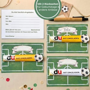 May include: A collection of invitation cards with a soccer theme. The cards feature a green field design, a soccer ball, and the words "Du bist eingeladen." A pen and a small soccer ball decoration are also present.