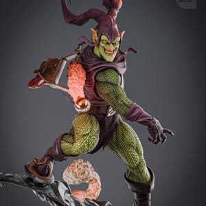 May include: Green Goblin action figure with a green and purple costume, holding a pumpkin bomb and riding a glider. The figure is posed in a dynamic action pose with a menacing expression.