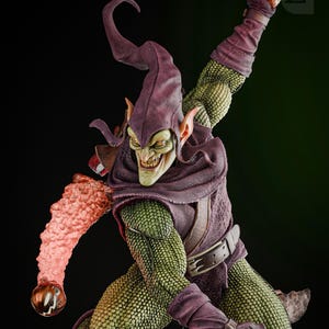 May include: Green Goblin action figure with a purple and green costume, a green face, and a menacing grin. He is holding a pumpkin bomb in his right hand and a glider in his left hand.