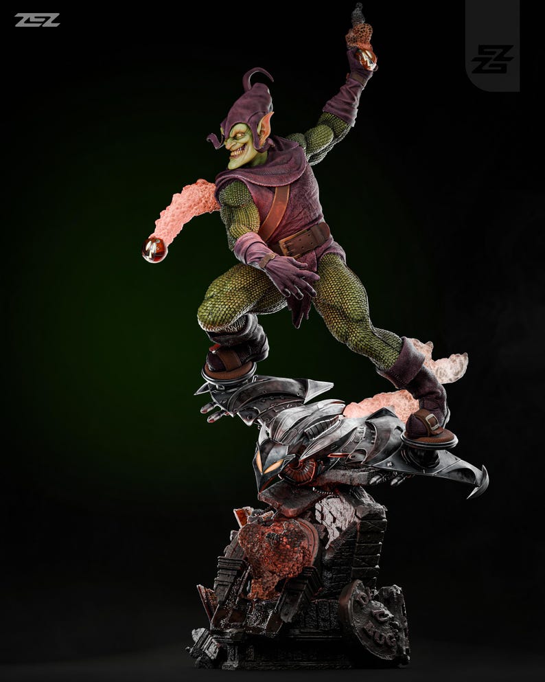 May include: Green Goblin action figure with a green and purple costume, holding a pumpkin bomb. The figure is posed in a dynamic action pose, standing on a black and gray base with a red and orange lava-like effect.