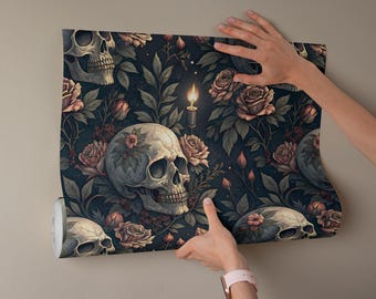 May include: Wallpaper roll featuring a dark floral pattern with skulls, roses, and a lit candle. The design includes skulls, roses, and foliage in shades of cream, pink, and green against a dark blue background.
