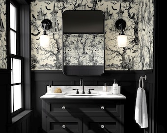 May include: A black and white bathroom with a spooky Halloween theme. The walls feature a black and white wallpaper with a haunted forest design. A black vanity with a marble countertop and a black framed mirror complete the look.