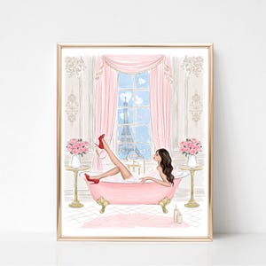 May include: A framed print of a woman relaxing in a pink bathtub, wearing red heels. The illustration features a view of the Eiffel Tower through a window, pink curtains, and floral accents. The artwork has a gold frame.