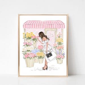 May include: A framed illustration of a woman smelling flowers outside a flower shop. The shop has a pink and white striped awning and a sign that says "OPEN". The woman is wearing a white dress and carrying shopping bags.