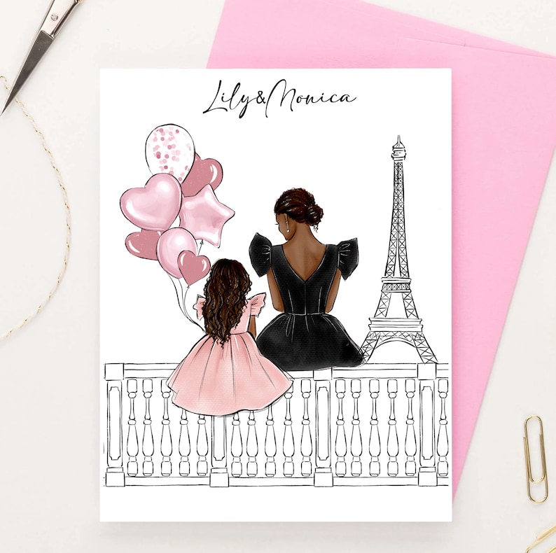 May include: A greeting card with a black and white illustration of two people standing on a balcony overlooking the Eiffel Tower. The people are holding pink balloons and the card says "Lily & Monica".