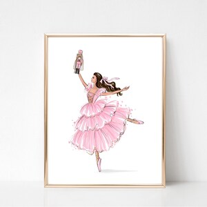 May include: A ballerina in a pink tutu holds a nutcracker doll in her right hand. She is wearing pink ballet shoes and has her left leg extended in a dance pose.