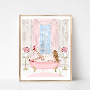 May include: A framed art print depicts a woman in a pink bathtub with red heels, bubbles, and a view of the Eiffel Tower. Pink curtains frame the window. Two small tables hold pink roses. The artwork has a gold frame.