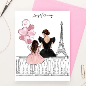 May include: A digital illustration of a mother and daughter standing on a balcony overlooking the Eiffel Tower in Paris. The mother is wearing a black dress and the daughter is wearing a pink dress. They are both looking out at the view. The text "Lucy & Mommy" is written at the top of the image.