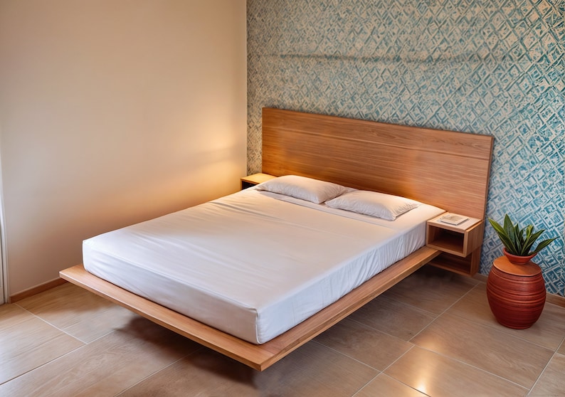 Puede incluir: Una cama plataforma de madera con un colch&oacute;n blanco y dos almohadas blancas. La cabecera est&aacute; hecha de madera y tiene un acabado de madera clara. Hay una peque&ntilde;a mesita de noche a cada lado de la cama.