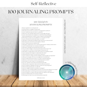 May include: A white printable PDF with the text "100 JOURNALING PROMPTS" and "Self-Reflective" at the top. The document includes a list of journaling prompts. A colorful circular logo is in the bottom right corner.