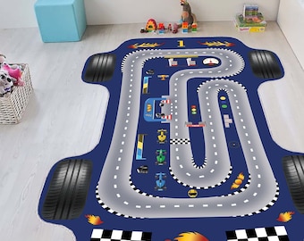 May include: A blue and gray race track rug with a checkered finish line and flames. The rug features a car racing track with a gray road and white lines. There are several toy cars on the track.