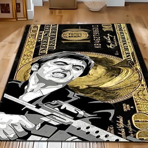 May include: A black and gold rug with a stylized image of a man holding a gun. The rug is designed to look like a $100 bill with the text "ONE HUNDRED DOLLARS" and "KB 46279860 I" printed on it.