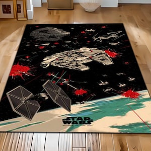 May include: A black and white Star Wars themed rug featuring a spaceship, TIE fighters, and the Death Star. The rug has a red and white design with the words "Star Wars" in white.