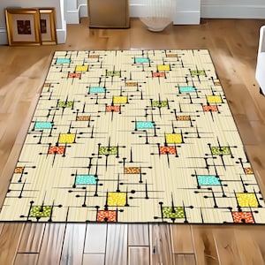 May include: A rectangular area rug featuring a cream-coloured background with a repeating pattern of black lines and dots. The design includes small squares in shades of yellow, orange, green, and light blue, each decorated with a white polka dot pattern.