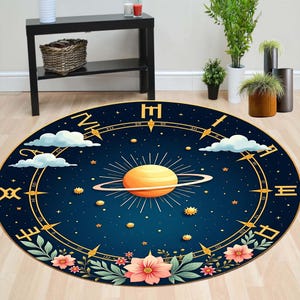 May include: A round rug with a celestial design. The rug features a dark blue background with a golden ringed planet, stars, clouds, and floral accents. The border has a clock-like design with Roman numerals.