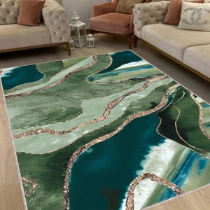 May include: Abstract area rug with a green, blue, and gold design. The rug features a swirling pattern of green and blue with gold accents.