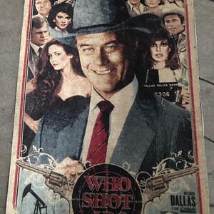 May include: A vintage poster with the text "WHO SHOT JR?" in a circular design, featuring actors and a distressed aesthetic. The poster includes images of oil derricks, guns, and the CBS Dallas logo.