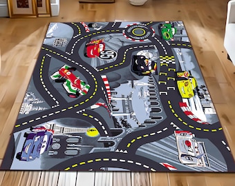 May include: A gray and black race track rug with colorful cartoon cars. The rug features a checkered finish line, a red car with the number 95, and a yellow car with the number 77.