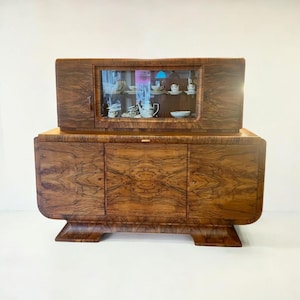 Art Deco sideboard with a manufacturing certificate from 1922. Solid wood veneered with burlwood and an extendable marble worktop.
