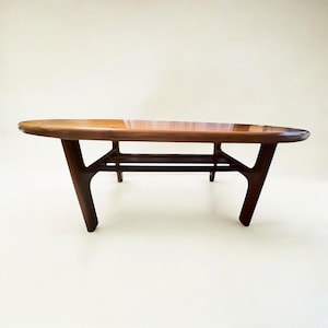 Danish design 1960s coffee table with newspaper rack in solid teak by Niels Bach for Randers Mobelfabrik in very good condition.