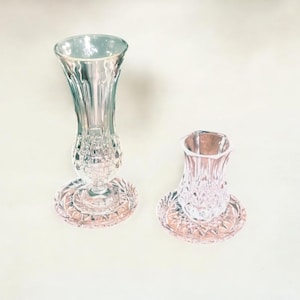 Beautiful small pressed glass vases with matching coasters from the 1960s. Their shape makes them perfect as a chai tea set.
