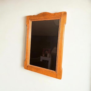 Original mid-century wall mirror with a rustic solid wood frame. Medium-sized 1960s mirror.