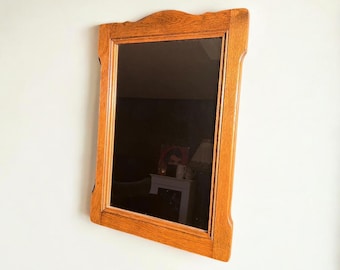 Original mid-century wall mirror with a rustic solid wood frame. Medium-sized 1960s mirror.