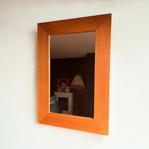 A vintage mirror from the 1920s to 1930s with a surprisingly modern design. Antique/shabby chic mirror with a mid-century modern look.