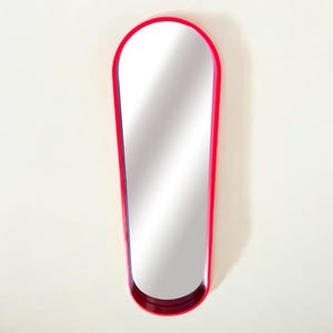 Mid-Century Modern wall mirror in red. Rare red lacquered solid wood frame, oval shaped 60s mirror