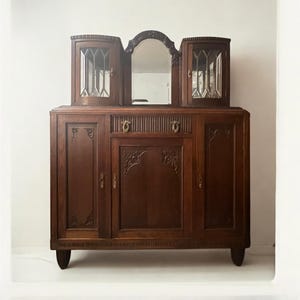 Beautiful small Art Nouveau / Art Deco sideboard with beveled glass and a mirror, dating from 1915 to 1925.