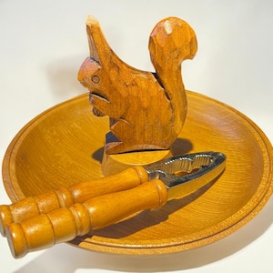 1960s mid-century wooden nut bowl, hand-carved with a squirrel and vintage nutcracker.