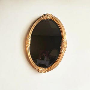 Oval Art Nouveau / Art Deco beveled mirror. Original vintage, the perfect size, with a gold frame and rose decoration.
