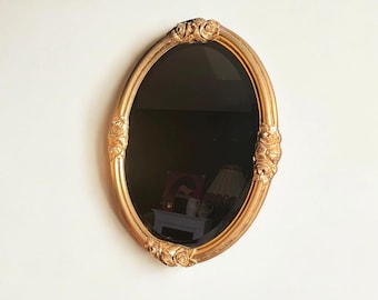 Oval Art Nouveau / Art Deco beveled mirror. Original vintage, the perfect size, with a gold frame and rose decoration.