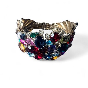 Exceptional vintage bangle from the 1980s. Extremely high-quality craftsmanship. Colorful gemstones set in brass and gold-plated.
