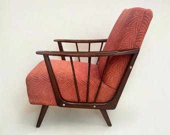 Vintage cocktail/lounge chair with walnut armrests and original red fabric upholstery. A classic from the 1950s/60s.