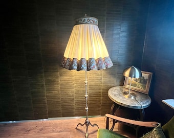 Bronze/brass floor lamp in a beautiful Art Deco design. Very solid and elaborately crafted with a brocade shade.