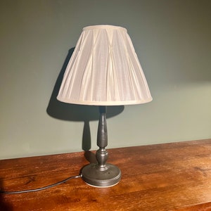 Table lamp with a high-quality, gathered white silk shade