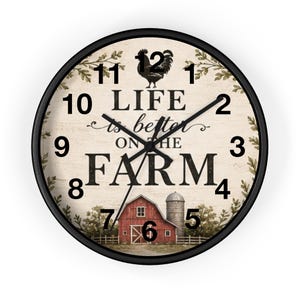 May include: A round wall clock with a black frame and a cream-colored face. The clock features black numerals, a black rooster silhouette, and the text "LIFE is better ON THE FARM" in black. A red barn and silo are illustrated at the bottom.