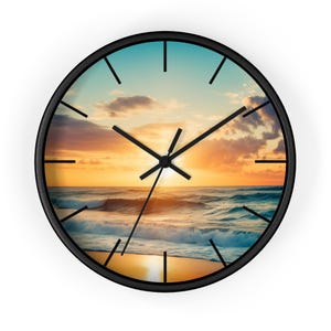 May include: A round wall clock with a black frame featuring a printed image of a sunset over the ocean. The clock face displays a golden sun low on the horizon, waves crashing on a sandy beach, and a sky with clouds. It has black hour, minute, and second hands.
