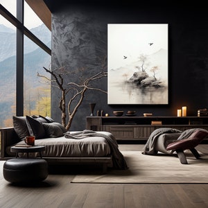 May include: A minimalist bedroom interior with a dark grey wall, a large window with a view of a mountain range, a bed with a grey headboard and a grey blanket, a dark wood side table with a small round stool, a dark wood cabinet with a painting of a misty landscape with a small island and birds, and a brown leather armchair with a grey throw blanket.