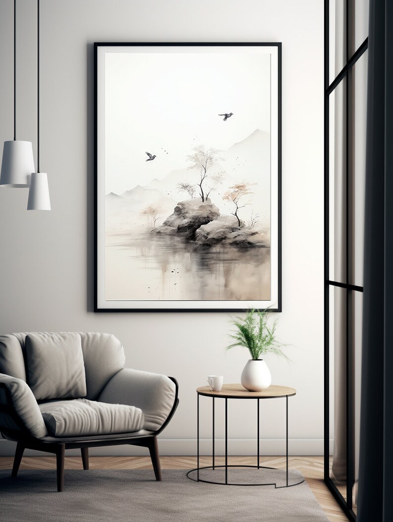 May include: A black framed print of a watercolor painting depicting a small island with trees and rocks in a misty landscape. Two birds fly overhead.