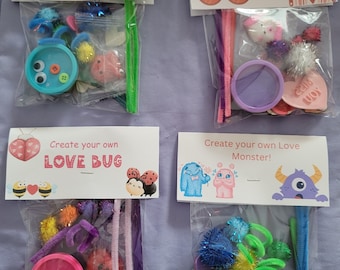 May include: Four bags with craft supplies for making Valentine's Day crafts. Each bag has a different theme: Heart-O-Saurus, Conversation Heart Valentine, Love Bug, and Love Monster. The bags contain pipe cleaners, pom-poms, googly eyes, and other craft supplies.