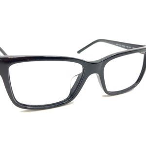 May include: Black rectangular eyeglasses with a thin frame.