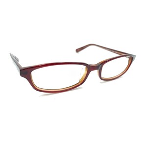 May include: A pair of eyeglasses with a dark red, semi-translucent plastic frame. The rectangular lenses are clear, and the frame features a subtle gradient effect, transitioning from a deep red outer edge to a lighter, amber-toned inner rim.