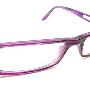 May include: Purple plastic framed eyeglasses with clear lenses.